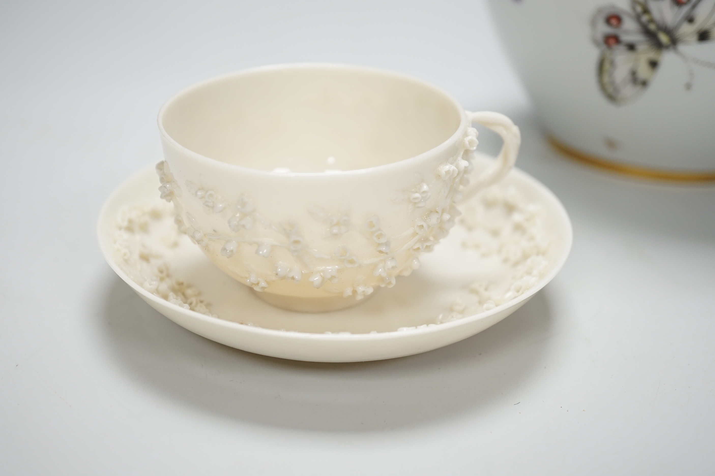 A Nyon style porcelain hand painted vase and a Belleek style coffee cup and saucer, tallest 18cm